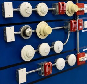 photo of a collection of fire sensors, alarms, conduits and pull stations