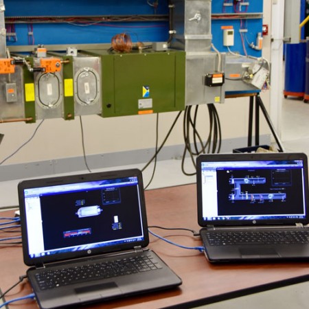 two laptop computers connected to HVAC control panels