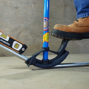 a close-up of a work boot stepping on a conduit bending tool
