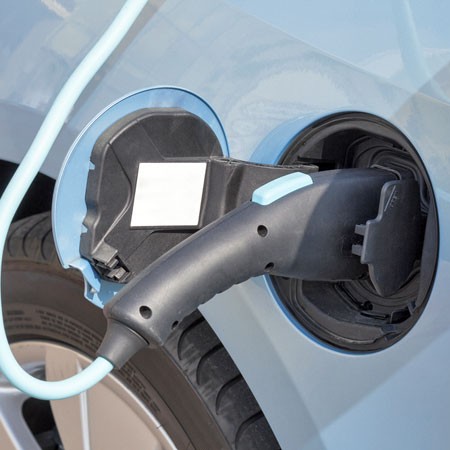 close-up view of an automotive electrical plug inserted into a vehicle's charging jack