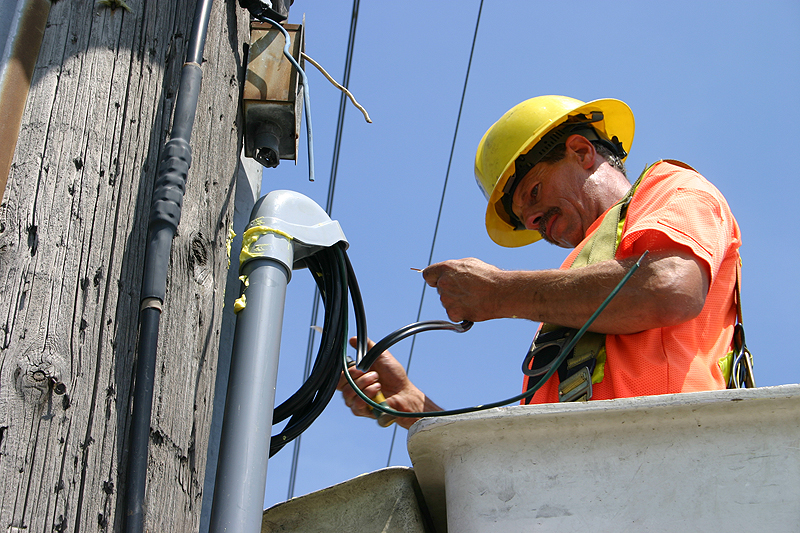 electrical worker connecting power lines