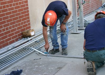 electrical worker working with conduit pipe