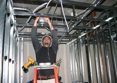 electrical worker installing ceiling fan
