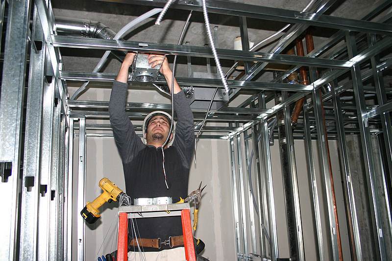 electrical worker installing ceiling fan