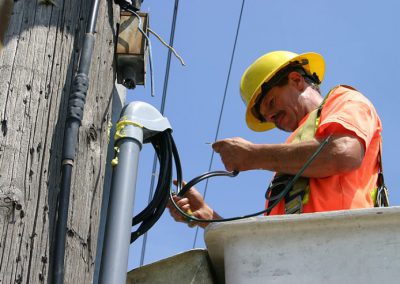 electrical worker connecting power lines