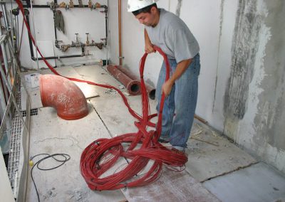 electrical worker unraveling electrical wiring