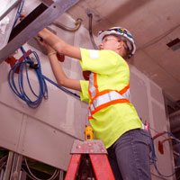 Female electrician running wiring