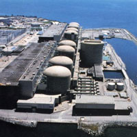 Aerial view of a nuclear power generating station near a body of water